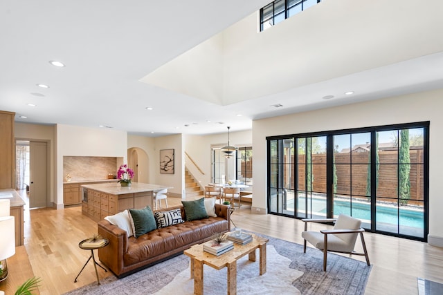 7158 Pasadena Ave, Dallas, TX 75214 - living room with arched walkways, light wood-style floors, recessed lighting, and baseboards