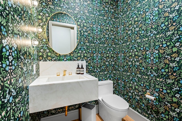 7158 Pasadena Ave, Dallas, TX 75214 - half bath with wallpapered walls, toilet, and vanity