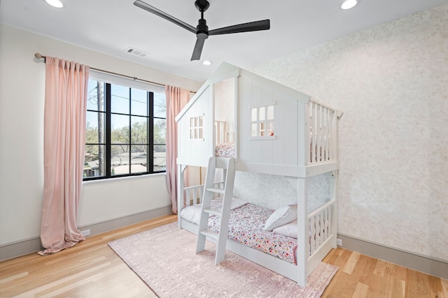 7158 Pasadena Ave, Dallas, TX 75214 - bedroom featuring wallpapered walls, an accent wall, baseboards, recessed lighting, and wood finished floors