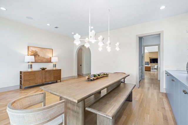 7158 Pasadena Ave, Dallas, TX 75214 - dining area with arched walkways, wallpapered walls, a chandelier, recessed lighting, and baseboards