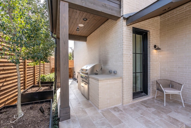 7158 Pasadena Ave, Dallas, TX 75214 - view of patio / terrace with exterior kitchen, fence, and grilling area