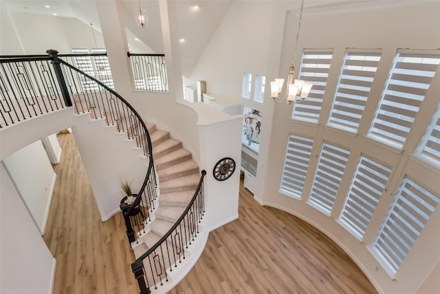 1108 Silverthorn Trl, Justin, TX 76247 - staircase featuring high vaulted ceiling, wood finished floors, a chandelier, recessed lighting, and baseboards