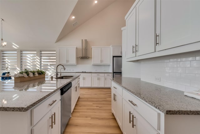 1108 Silverthorn Trl, Justin, TX 76247 - kitchen featuring appliances with stainless steel finishes, a sink, wall chimney exhaust hood, backsplash, and lofted ceiling