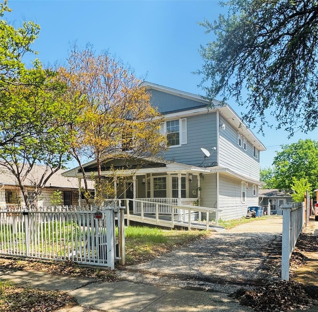 510 S Waverly Dr, Dallas, TX 75208 - view of front of home with gravel driveway, a porch, and a fenced front yard