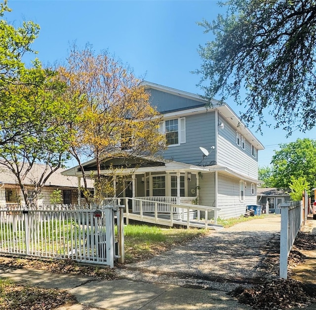 510 S Waverly Dr, Dallas, TX 75208 - view of front of home with gravel driveway, a porch, and a fenced front yard
