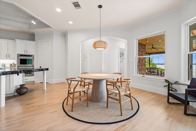 1190 Emerald Sound Blvd, Oak Point, TX 75068 - dining area featuring ornamental molding, light wood-style flooring, arched walkways, baseboards, and recessed lighting