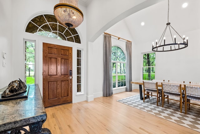 1190 Emerald Sound Blvd, Oak Point, TX 75068 - entrance foyer with a chandelier, light wood-style flooring, recessed lighting, arched walkways, and high vaulted ceiling