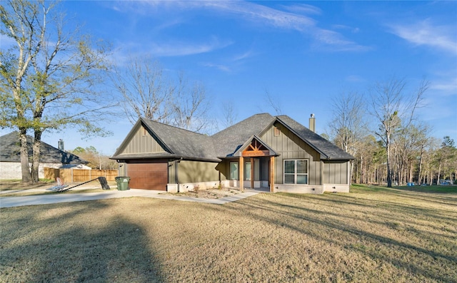 12908 County Road 463, Tyler, TX 75706 - view of front of property with board and batten siding, fence, a front lawn, an attached garage, and driveway