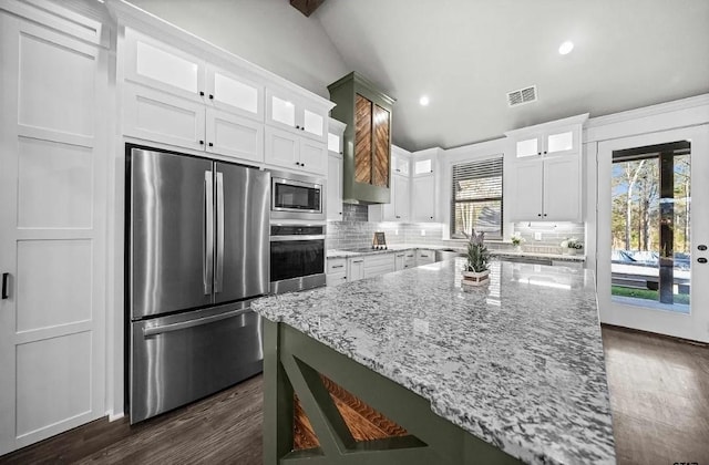 12908 County Road 463, Tyler, TX 75706 - kitchen with tasteful backsplash, white cabinets, appliances with stainless steel finishes, and dark wood-style flooring