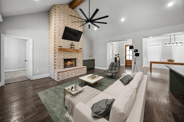 12908 County Road 463, Tyler, TX 75706 - living area featuring high vaulted ceiling, beamed ceiling, a fireplace, a ceiling fan, and wood finished floors