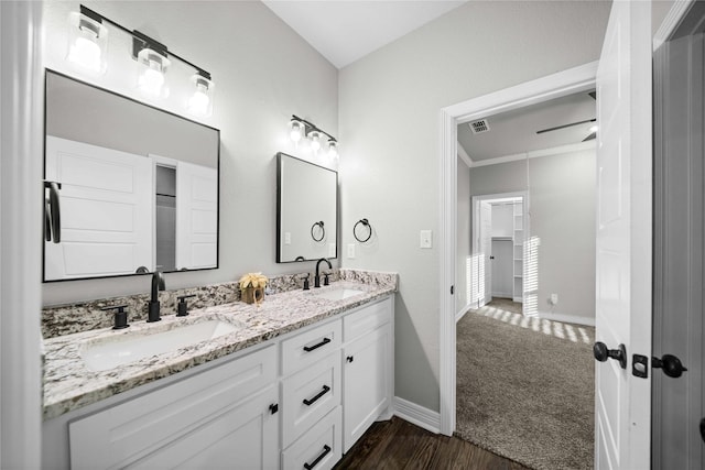 12908 County Road 463, Tyler, TX 75706 - bathroom with double vanity, visible vents, baseboards, and a sink