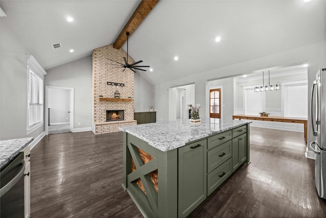 12908 County Road 463, Tyler, TX 75706 - kitchen with green cabinetry, dark wood-style flooring, ceiling fan, appliances with stainless steel finishes, and beam ceiling