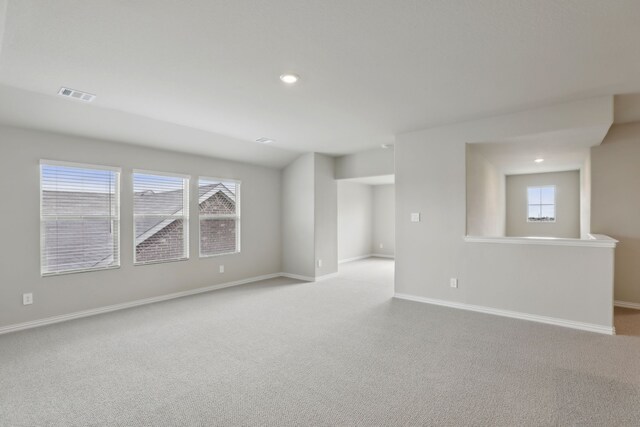 spare room with baseboards, visible vents, and plenty of natural light