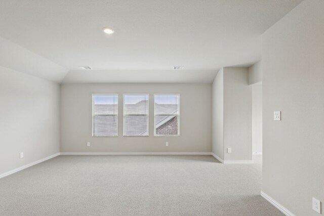 spare room with light colored carpet, baseboards, visible vents, and recessed lighting