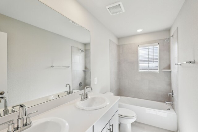 bathroom featuring a sink, toilet, shower / washtub combination, and visible vents