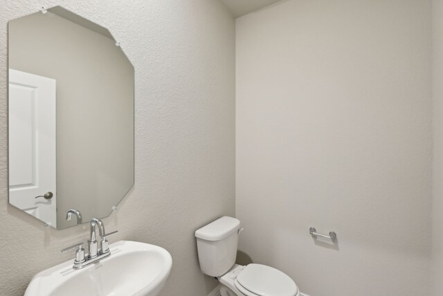 bathroom featuring toilet and a sink