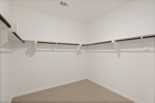 spacious closet with visible vents and carpet floors