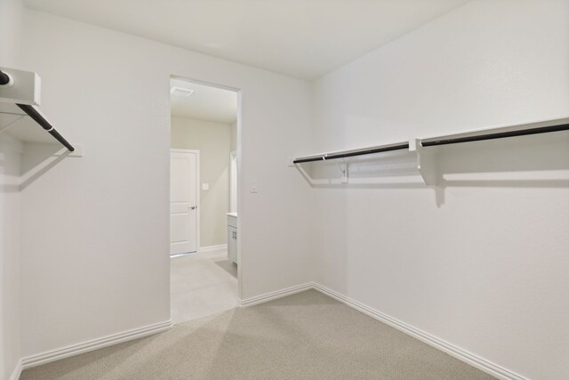 spacious closet with light colored carpet