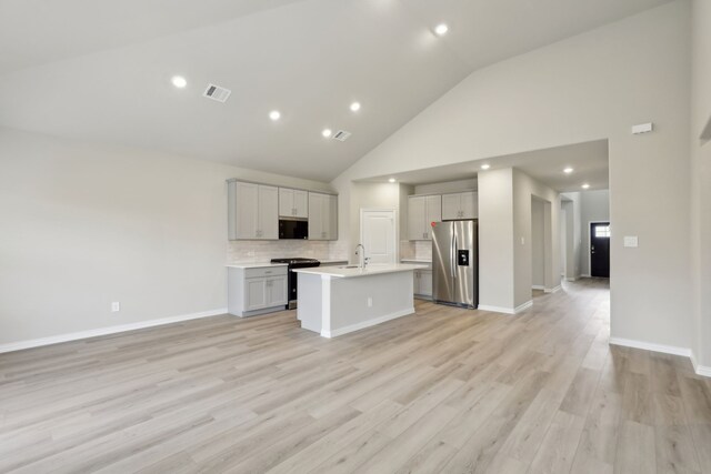 kitchen featuring open floor plan, light countertops, visible vents, and appliances with stainless steel finishes