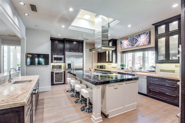10989 Crooked Creek Dr, Dallas, TX 75229 - kitchen featuring a large island, a sink, beverage cooler, built in appliances, and recessed lighting