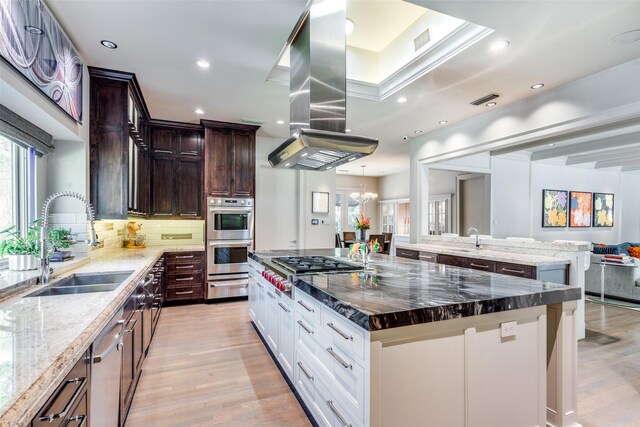 10989 Crooked Creek Dr, Dallas, TX 75229 - kitchen featuring a sink, a warming drawer, light wood-style flooring, a large island, and island exhaust hood