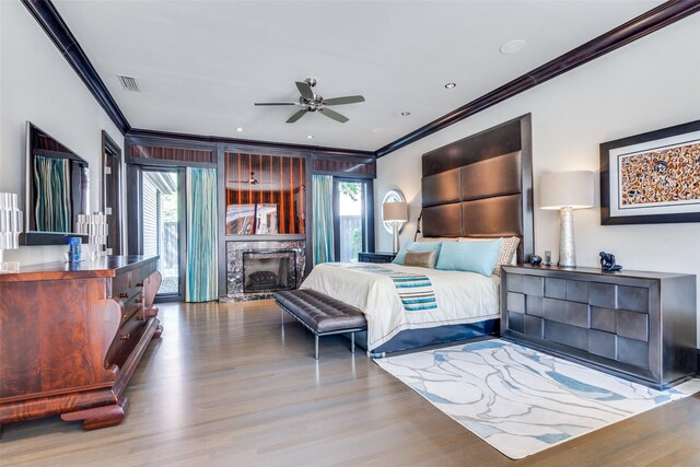 10989 Crooked Creek Dr, Dallas, TX 75229 - bedroom featuring crown molding, wood finished floors, and a stone fireplace