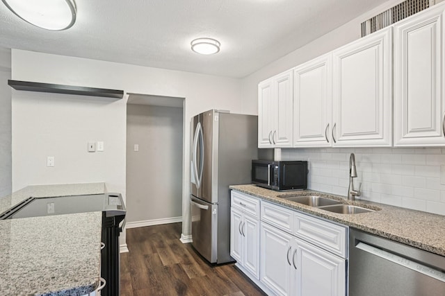 716 Meadow Mead Dr, Allen, TX 75002 - kitchen featuring stainless steel appliances, a sink, dark wood finished floors, and white cabinetry