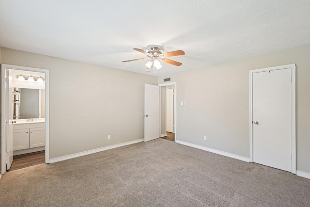 716 Meadow Mead Dr, Allen, TX 75002 - unfurnished bedroom featuring carpet floors, baseboards, ensuite bathroom, and ceiling fan