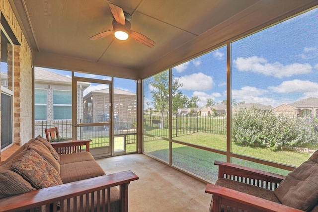 sunroom featuring a ceiling fan