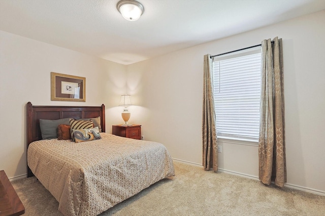 bedroom featuring carpet floors and baseboards