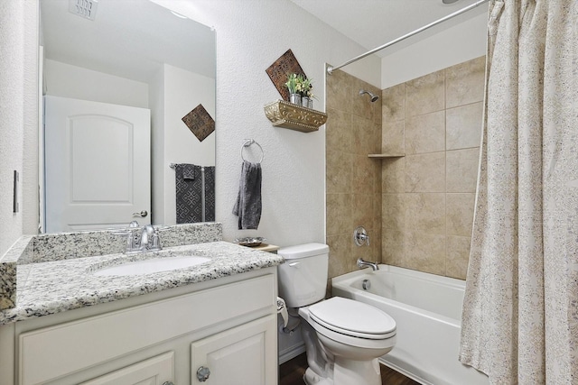 full bath with vanity, a textured wall, toilet, shower / bathtub combination with curtain, and visible vents