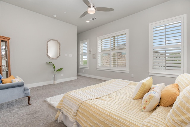 bedroom with a ceiling fan, visible vents, light carpet, and baseboards