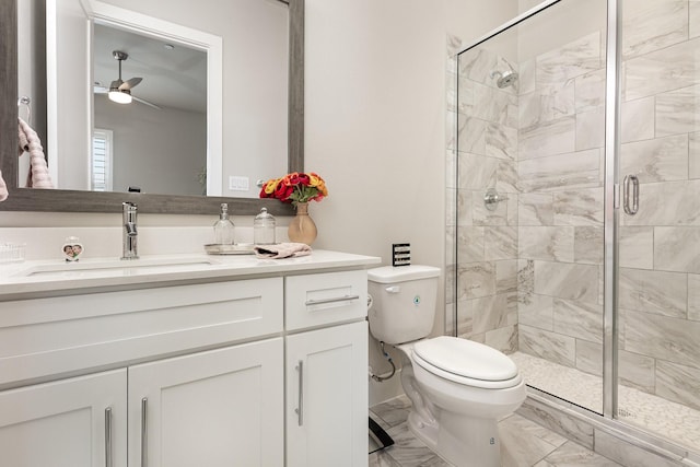 full bath featuring a shower stall, marble finish floor, toilet, vanity, and a ceiling fan