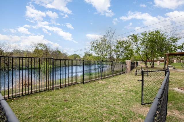 view of yard with a water view and fence