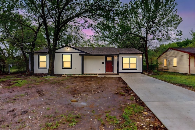 6840 Hillmont Dr, Dallas, TX 75217 - view of front facade with a shingled roof, concrete driveway, and fence