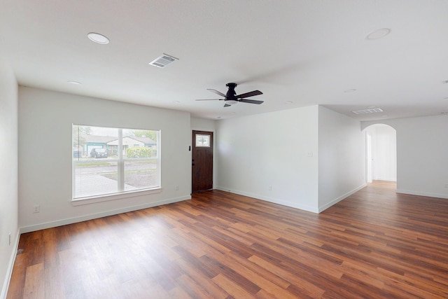 6840 Hillmont Dr, Dallas, TX 75217 - unfurnished living room featuring arched walkways, visible vents, a ceiling fan, and wood finished floors