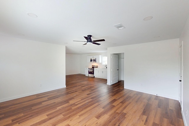 6840 Hillmont Dr, Dallas, TX 75217 - unfurnished living room with ceiling fan, baseboards, dark wood finished floors, and visible vents