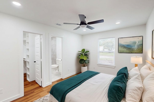 6840 Hillmont Dr, Dallas, TX 75217 - bedroom with visible vents, baseboards, light wood-style floors, recessed lighting, and a walk in closet