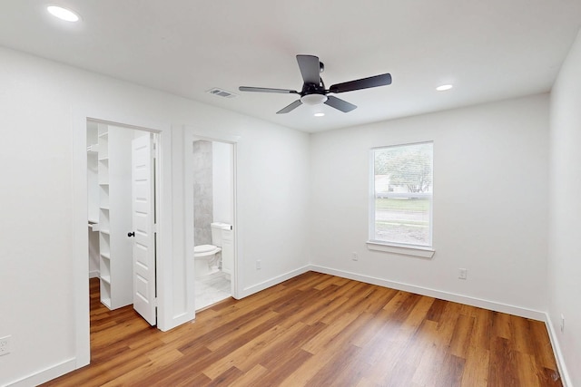 6840 Hillmont Dr, Dallas, TX 75217 - unfurnished bedroom featuring a closet, a spacious closet, visible vents, light wood finished floors, and baseboards
