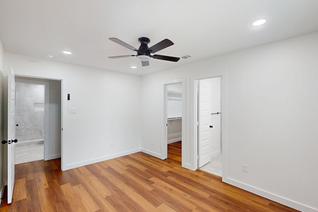 6840 Hillmont Dr, Dallas, TX 75217 - unfurnished bedroom with light wood-type flooring, a spacious closet, visible vents, and recessed lighting