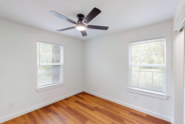 6840 Hillmont Dr, Dallas, TX 75217 - spare room featuring light wood-style flooring, a ceiling fan, and baseboards