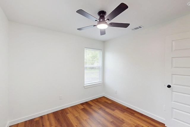 6840 Hillmont Dr, Dallas, TX 75217 - unfurnished room featuring visible vents, baseboards, a ceiling fan, and wood finished floors
