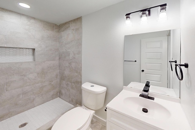 6840 Hillmont Dr, Dallas, TX 75217 - full bathroom with vanity, a tile shower, and toilet