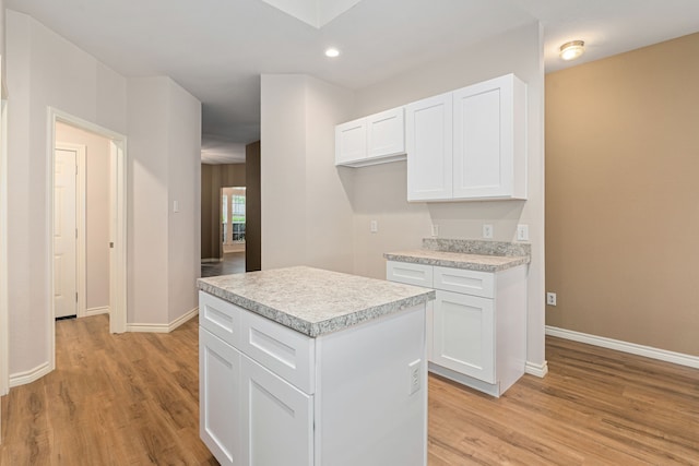 5013 Royal Burgess Dr, Fort Worth, TX 76135 - kitchen with white cabinets, light wood-style floors, light countertops, and baseboards