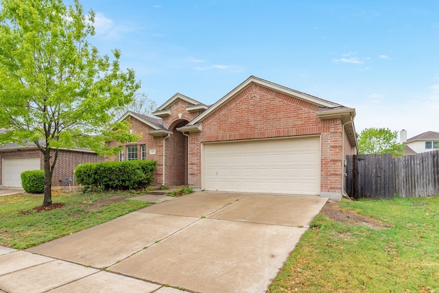 5013 Royal Burgess Dr, Fort Worth, TX 76135 - view of front of home featuring a front lawn, concrete driveway, fence, brick siding, and an attached garage