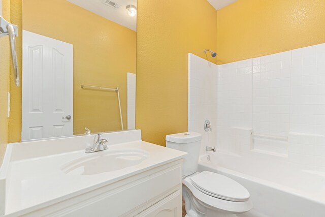 5013 Royal Burgess Dr, Fort Worth, TX 76135 - bathroom featuring a textured wall, toilet, vanity, and shower / washtub combination