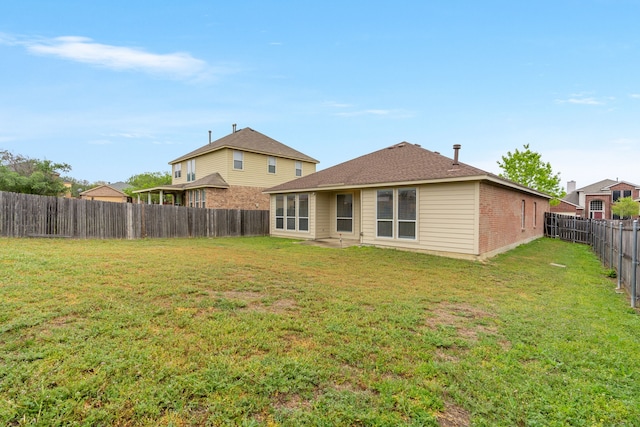5013 Royal Burgess Dr, Fort Worth, TX 76135 - rear view of property featuring a fenced backyard, brick siding, and a yard