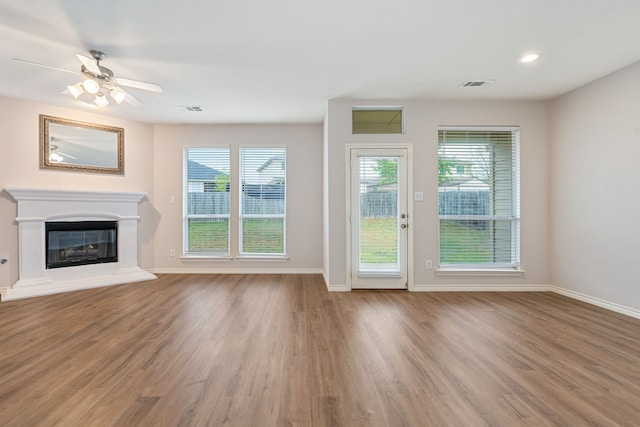 5013 Royal Burgess Dr, Fort Worth, TX 76135 - unfurnished living room featuring wood finished floors, visible vents, and baseboards