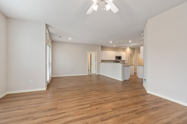 5013 Royal Burgess Dr, Fort Worth, TX 76135 - unfurnished living room featuring light wood-style flooring, baseboards, recessed lighting, and ceiling fan