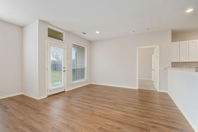 5013 Royal Burgess Dr, Fort Worth, TX 76135 - unfurnished living room with baseboards, light wood-style floors, visible vents, and recessed lighting